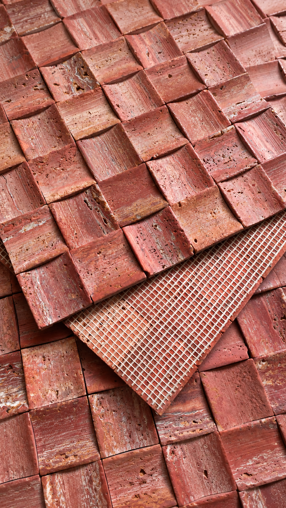 Two textured terracotta clay tiles with a woven basket-like pattern and a fine mesh grid pattern, displayed on a matching background.