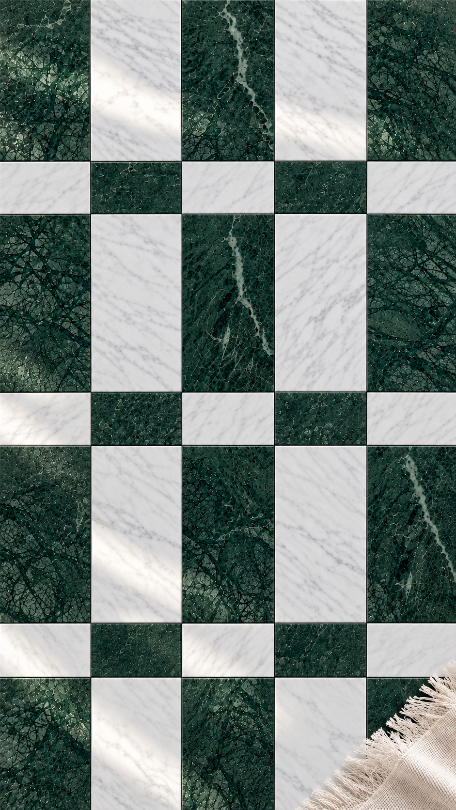 A checkered floor mat featuring alternating dark forest green marble and white marble squares, with a beige fringed edge visible in the bottom right corner.